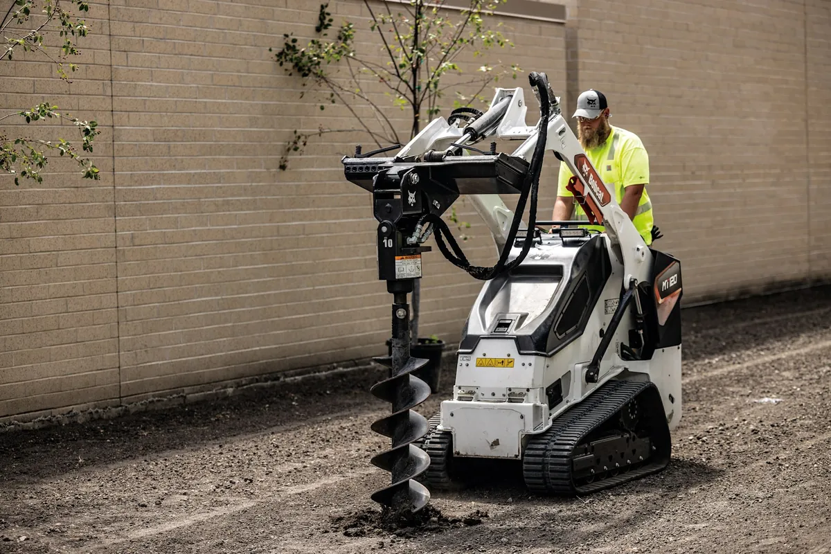 Bobcat MT120 mini track loader drilling with the auger